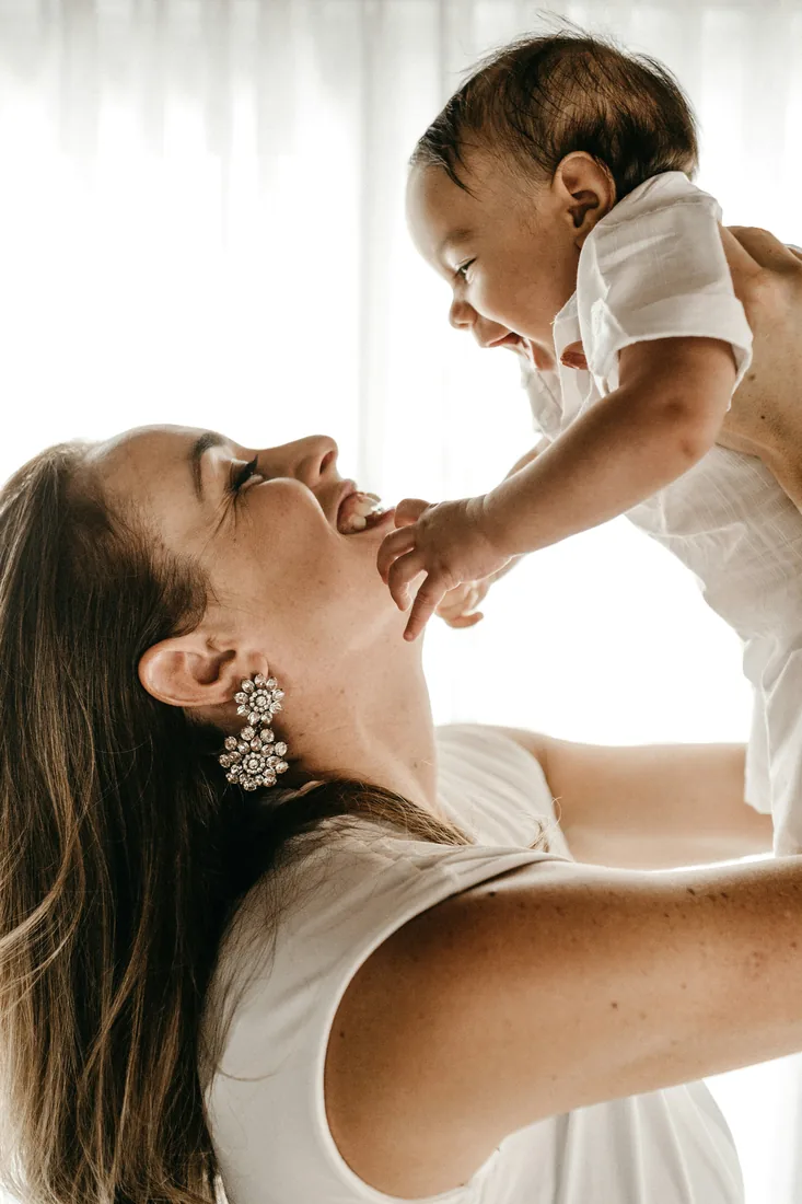 Mother holding her baby — mommy makeover body contouring in Austin, TX