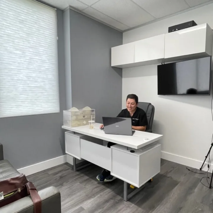 Dr. Andre Levesque reviewing a facelift plan with a patient during a consultation in Austin, TX